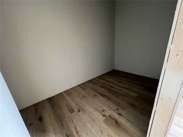 spare room with wood finished floors