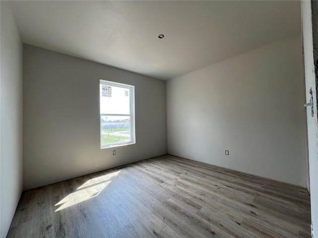 unfurnished room with wood finished floors
