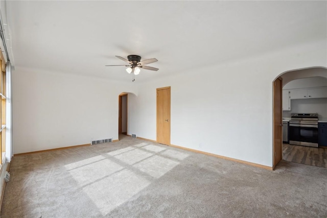 carpeted spare room with ceiling fan