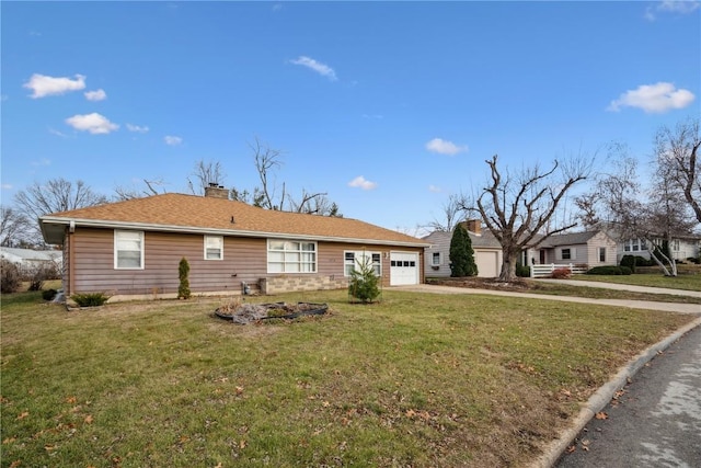 view of front of property with a front lawn and a garage