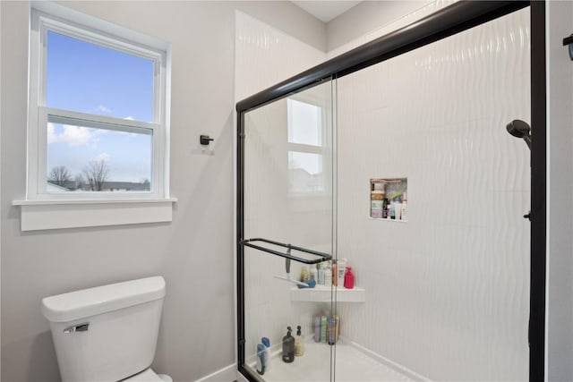 bathroom featuring toilet and walk in shower