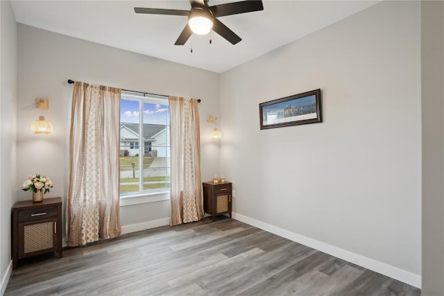 empty room with wood-type flooring and ceiling fan