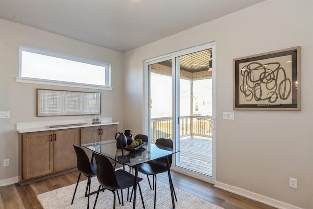 dining space with hardwood / wood-style floors