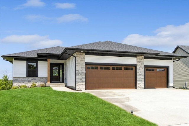 prairie-style home featuring a garage and a front yard