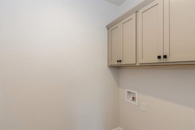 clothes washing area with cabinets and hookup for a washing machine