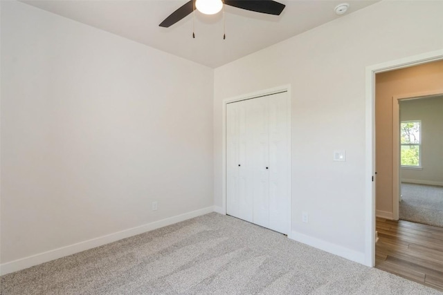 unfurnished bedroom with light wood-type flooring, a closet, and ceiling fan