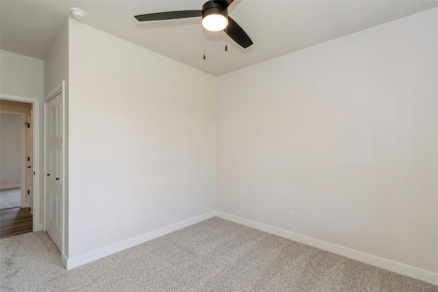 spare room featuring carpet flooring and ceiling fan