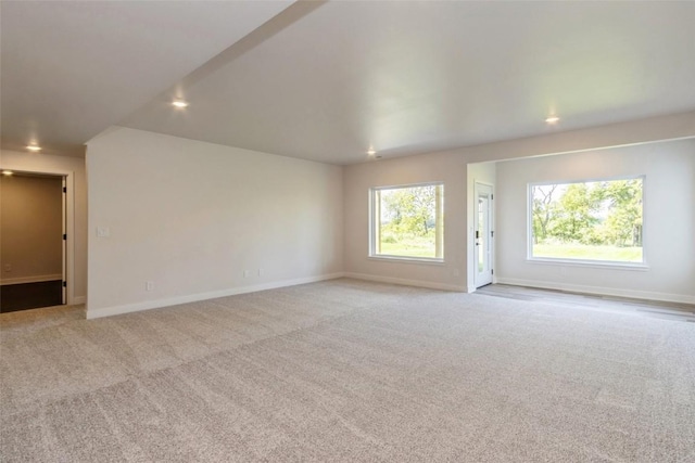 unfurnished living room featuring light carpet