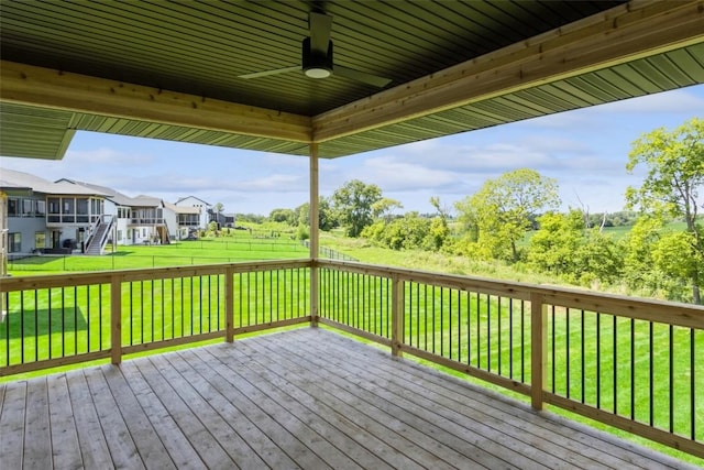 deck featuring ceiling fan and a yard