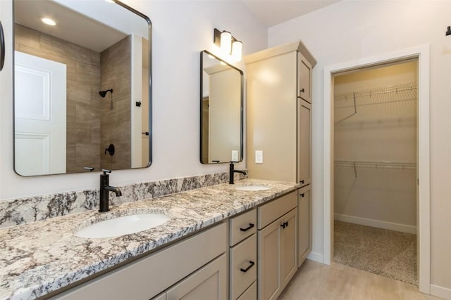 bathroom featuring vanity and tiled shower