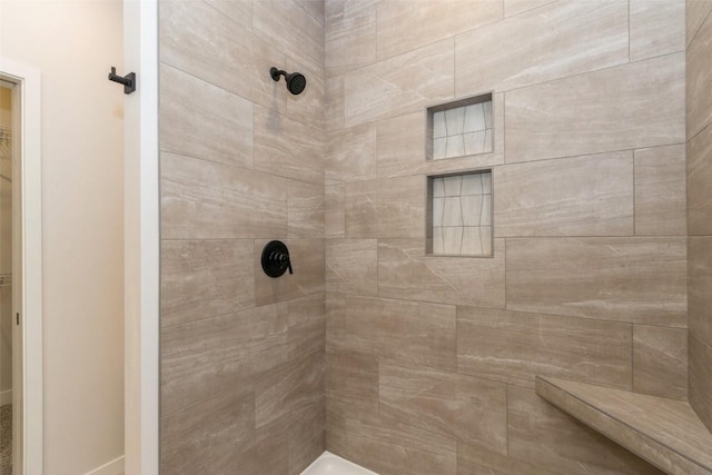 bathroom with a tile shower