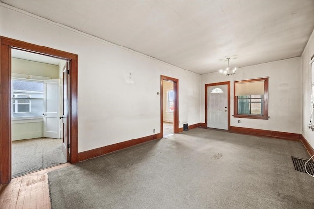 foyer with hardwood / wood-style flooring and an inviting chandelier