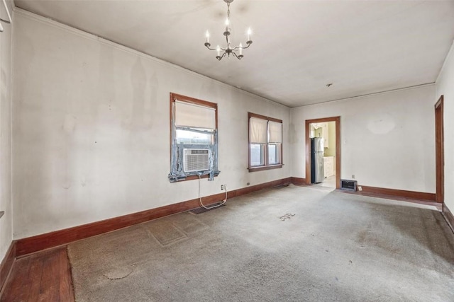 unfurnished room with a chandelier, wood-type flooring, cooling unit, and crown molding