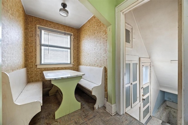 bathroom with parquet flooring and lofted ceiling