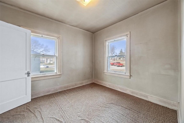 unfurnished room with carpet floors, a healthy amount of sunlight, and ornamental molding