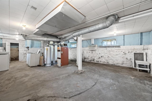 basement featuring washer / dryer, a wealth of natural light, and water heater