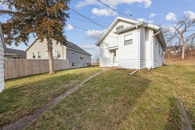 back of property featuring a lawn