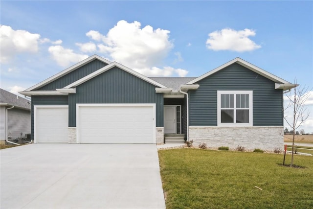 view of front of house with a garage and a front lawn