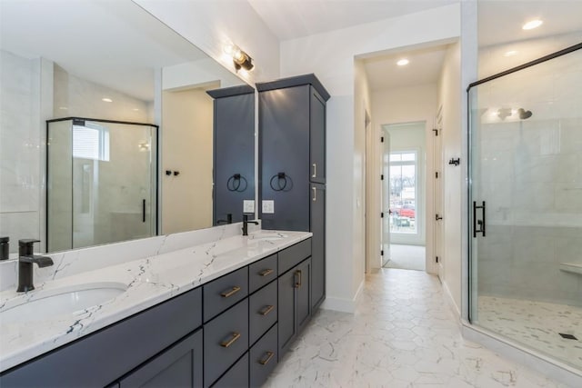 bathroom with vanity, an enclosed shower, and a healthy amount of sunlight