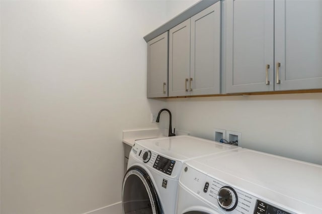 laundry area featuring cabinets and washer and clothes dryer