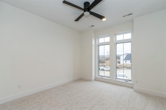 unfurnished room with light carpet and ceiling fan