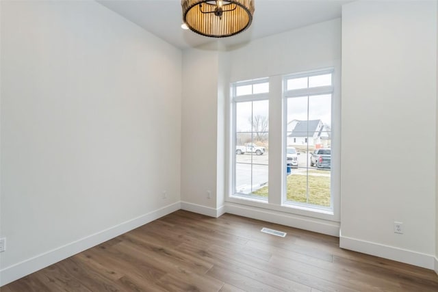 unfurnished room with hardwood / wood-style floors