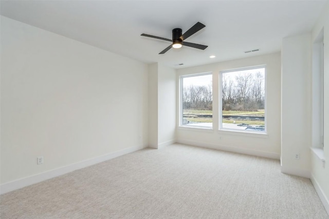 carpeted empty room featuring ceiling fan