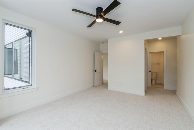 unfurnished bedroom with connected bathroom, ceiling fan, and light colored carpet