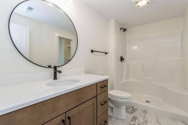 bathroom with a shower, vanity, and toilet