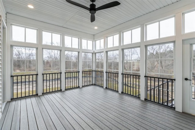 unfurnished sunroom with ceiling fan