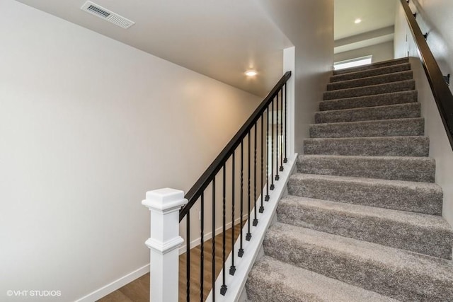 stairs with hardwood / wood-style flooring