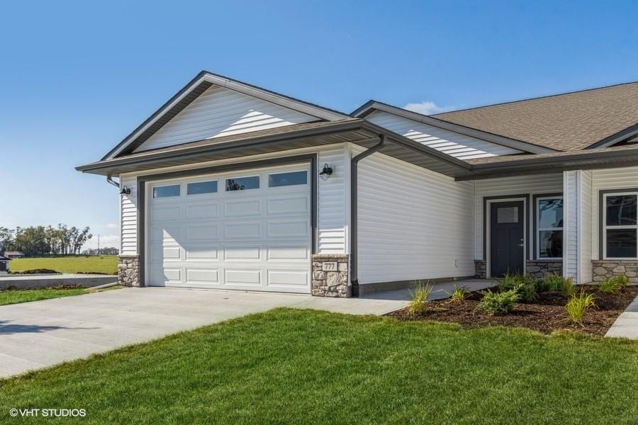 ranch-style house with a garage and a front yard