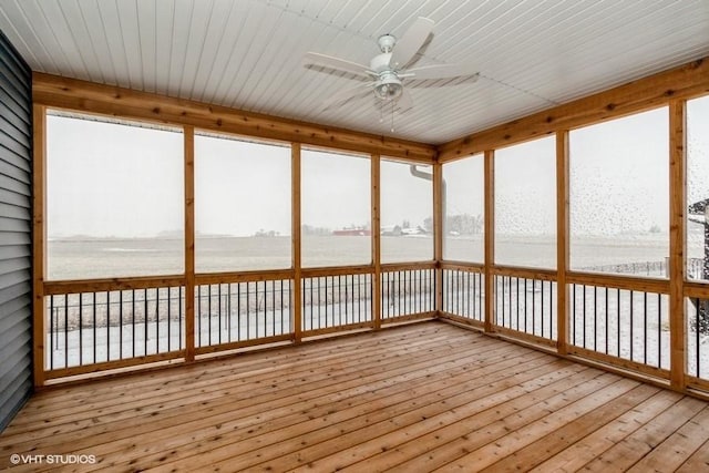 unfurnished sunroom with ceiling fan, a water view, and wooden ceiling