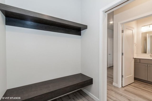 mudroom with light wood-type flooring and sink