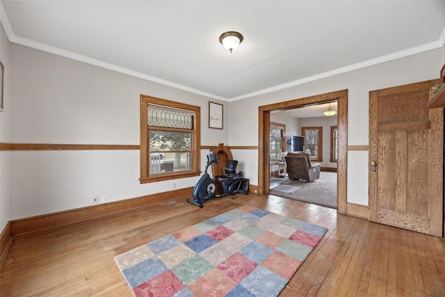 interior space with hardwood / wood-style floors and ornamental molding