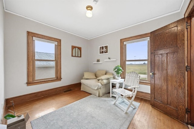 sitting room featuring light hardwood / wood-style flooring and crown molding