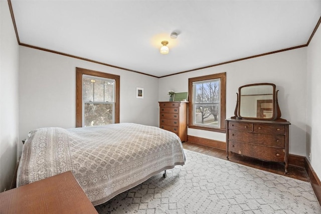 bedroom with wood-type flooring and ornamental molding