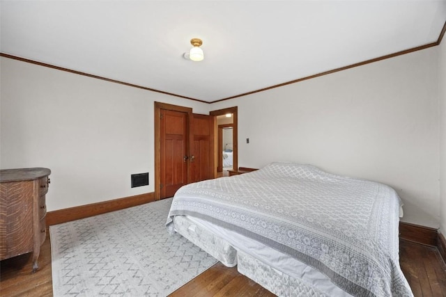 bedroom featuring crown molding and hardwood / wood-style floors