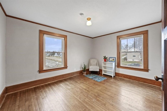 unfurnished room with hardwood / wood-style floors and crown molding