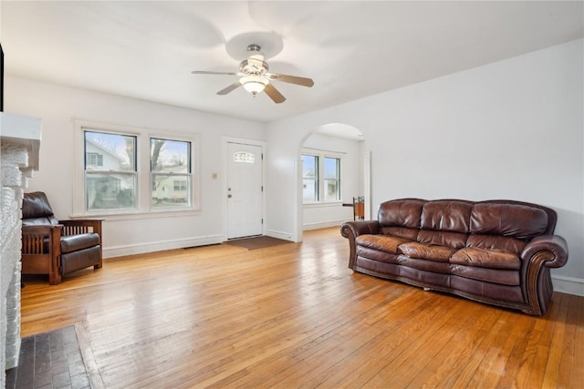 living room featuring light hardwood / wood-style floors and ceiling fan