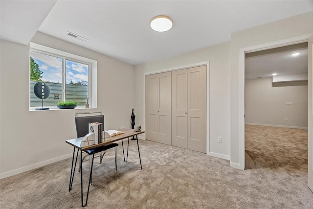 office area featuring light carpet