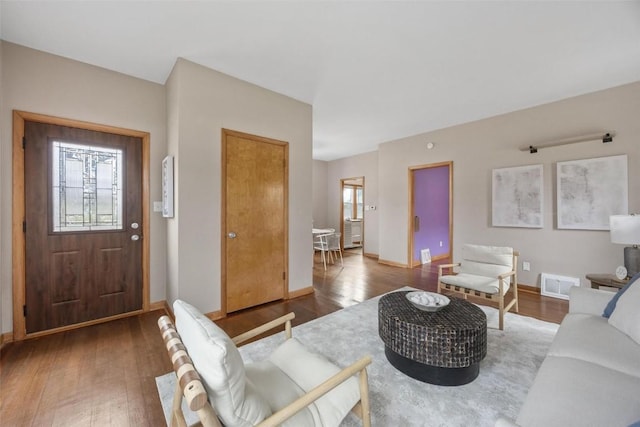 living room with plenty of natural light and dark wood-type flooring