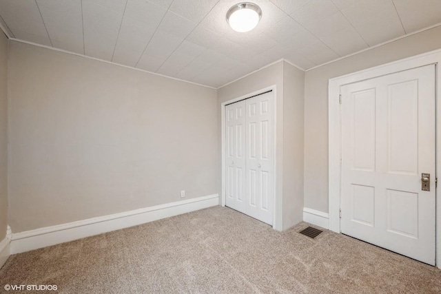 unfurnished bedroom featuring a closet and carpet