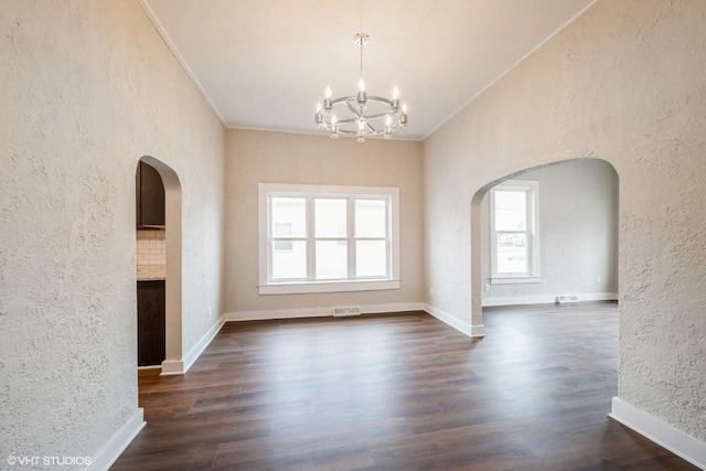 interior space with a chandelier, dark hardwood / wood-style floors, and crown molding