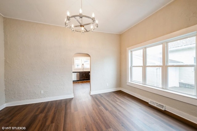 interior space featuring a chandelier, dark hardwood / wood-style flooring, and a healthy amount of sunlight