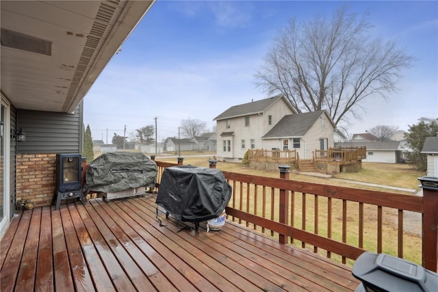 deck featuring a yard and grilling area