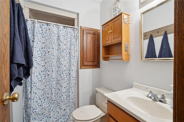 bathroom with vanity, a shower with shower curtain, and toilet