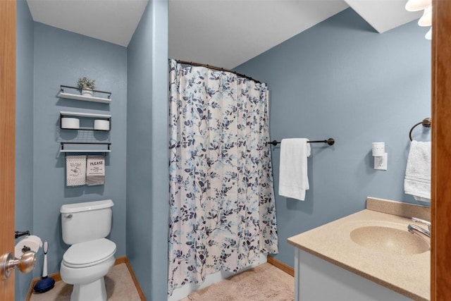 bathroom featuring curtained shower, vanity, and toilet