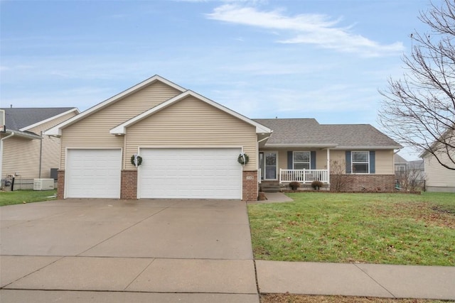 single story home with covered porch, a garage, and a front lawn