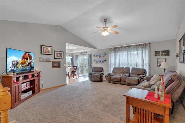 carpeted living room with ceiling fan and vaulted ceiling